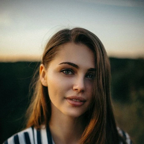 smiling woman wearing white and black pinstriped collared top