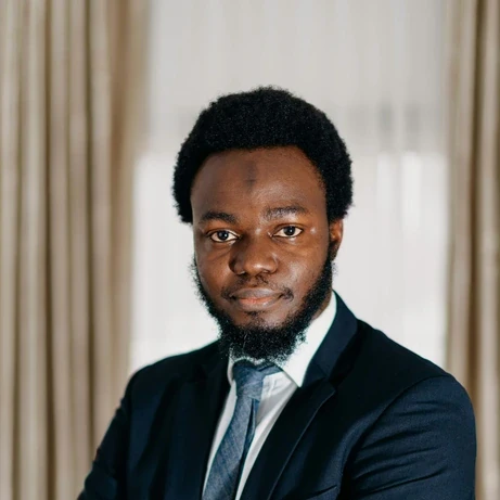 a man in a suit and tie posing for a picture